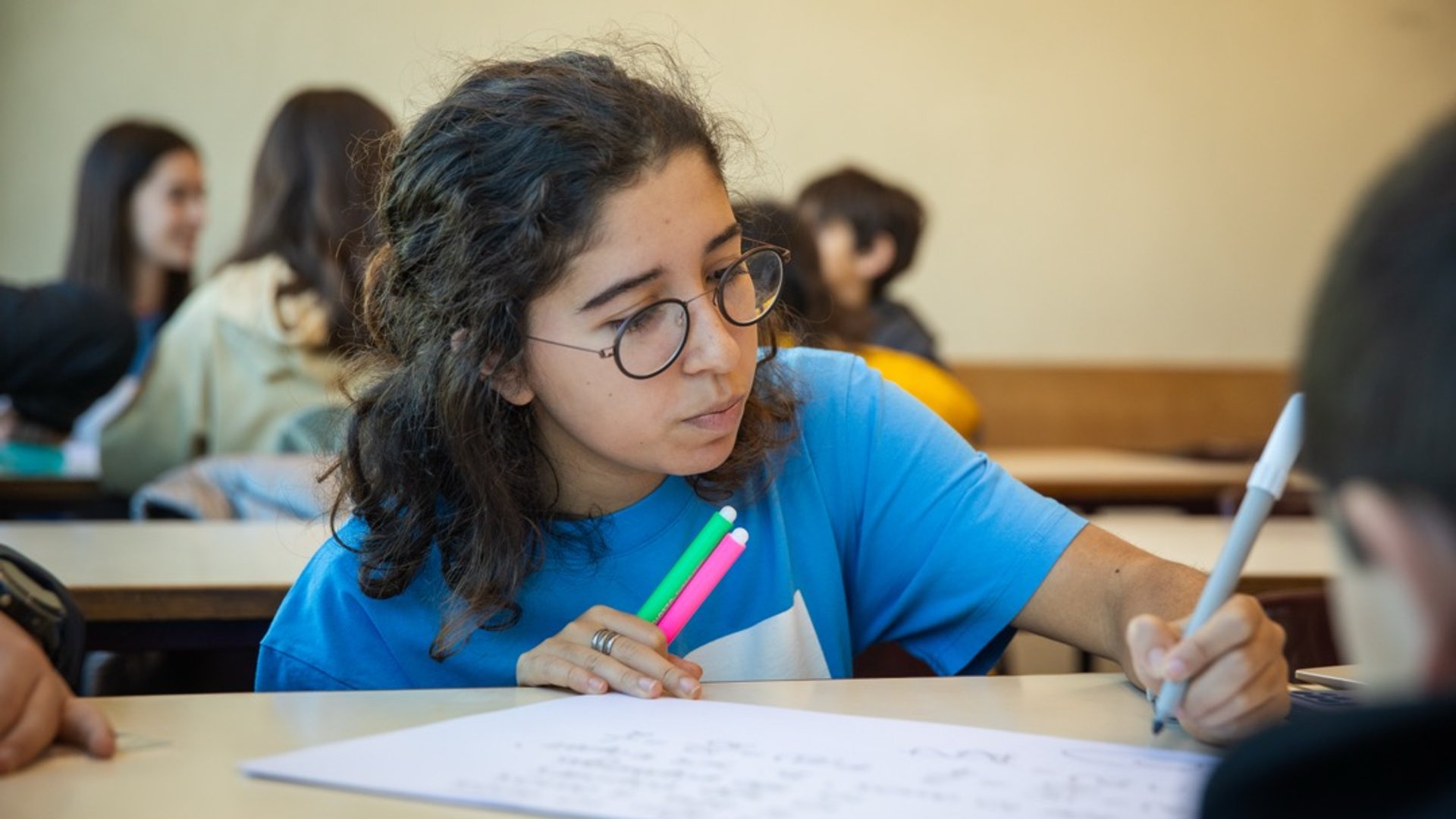 Instrutora explicando conceitos a dois alunos atentos